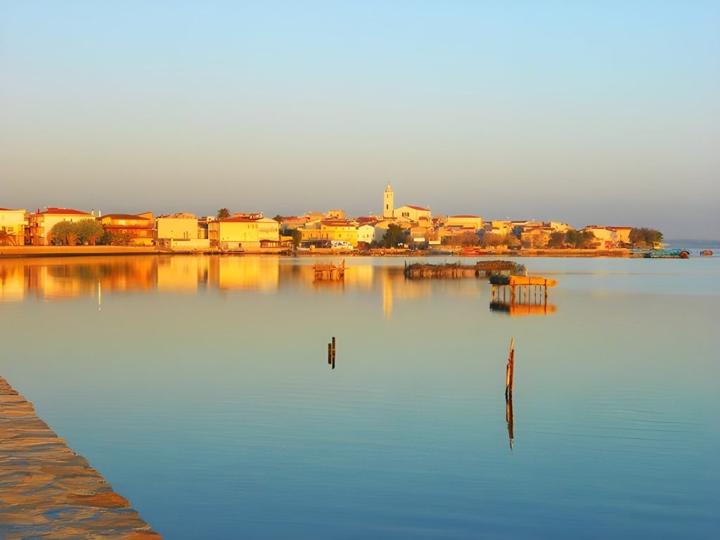 Il borgo di Lesina al tramonto visto dalla laguna